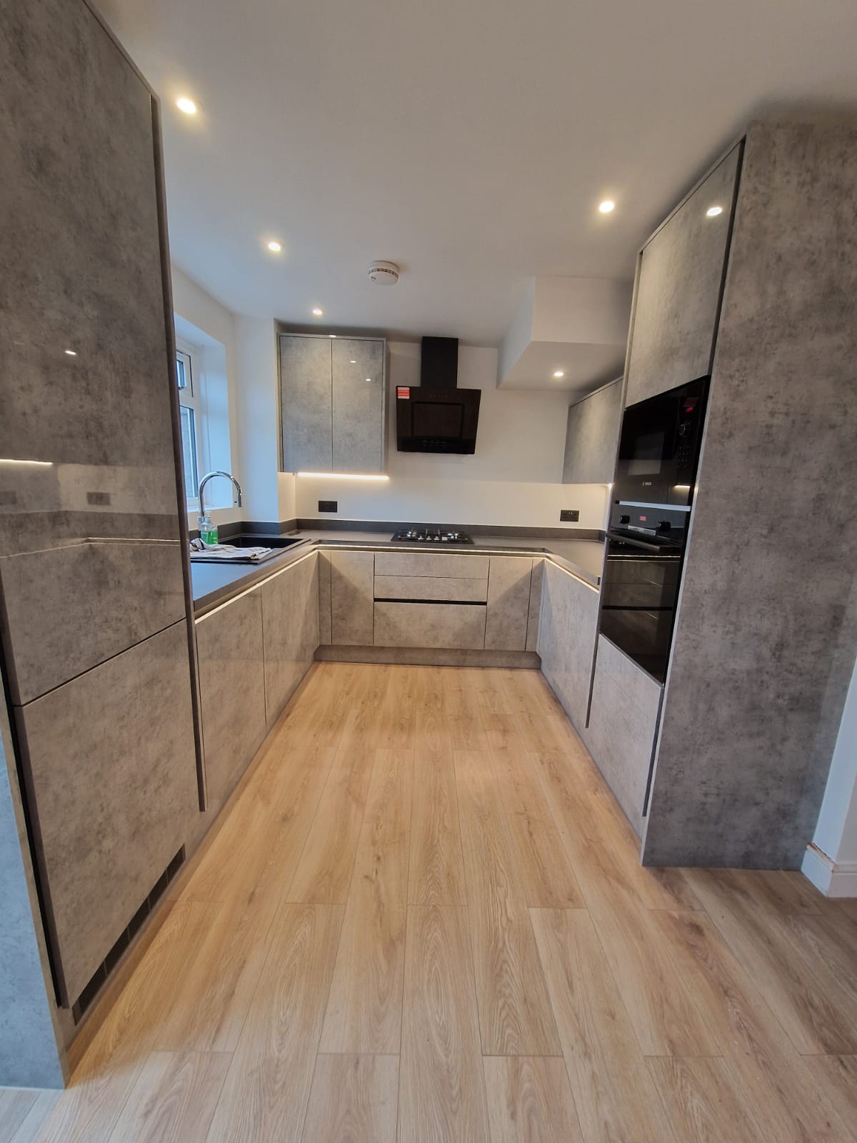 Concrete effect handleless kitchen